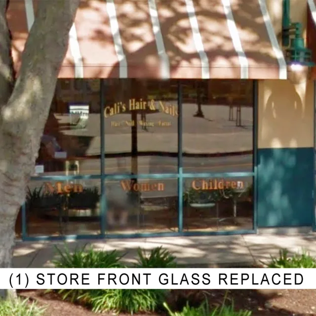 A salon storefront under a striped awning, labeled one store front glass replaced